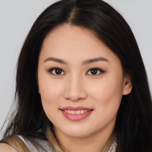 Joyful asian young-adult female with long  brown hair and brown eyes