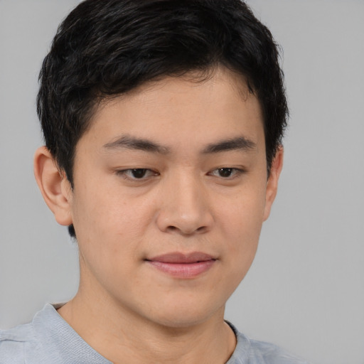 Joyful asian young-adult male with short  brown hair and brown eyes