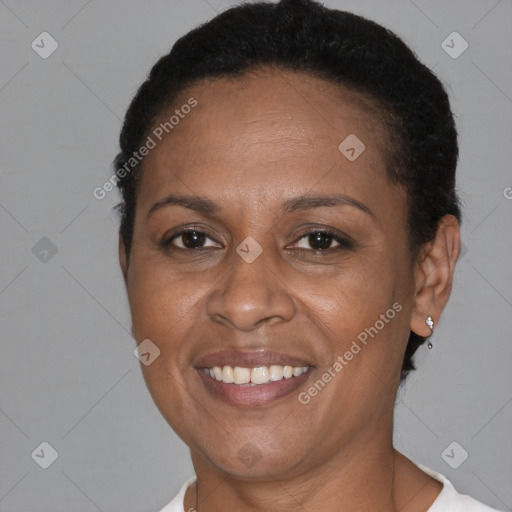 Joyful black adult female with short  brown hair and brown eyes