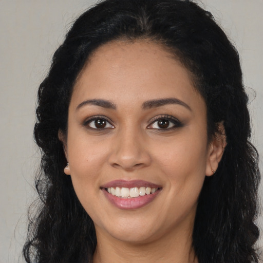 Joyful latino young-adult female with long  black hair and brown eyes