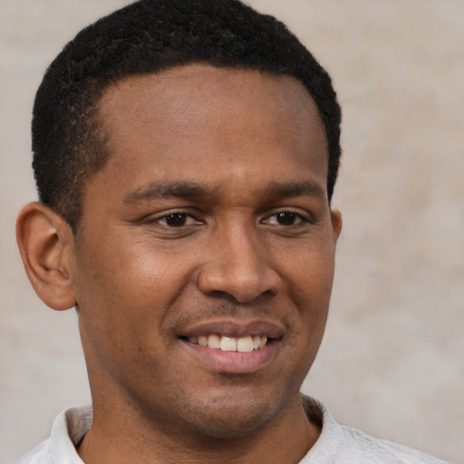 Joyful latino young-adult male with short  brown hair and brown eyes