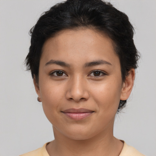 Joyful latino young-adult female with short  brown hair and brown eyes
