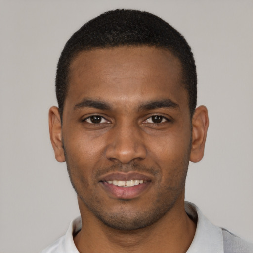 Joyful black young-adult male with short  black hair and brown eyes