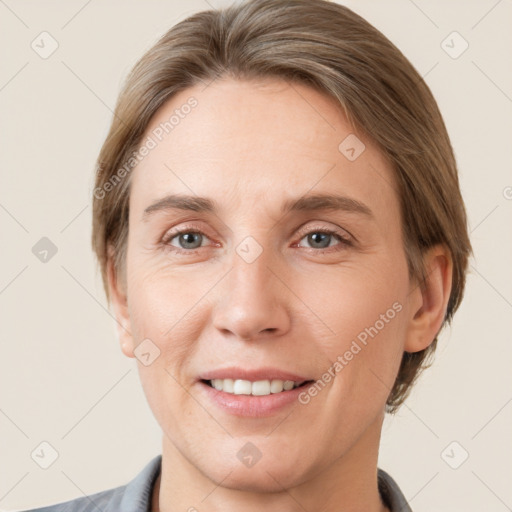 Joyful white adult female with short  brown hair and grey eyes