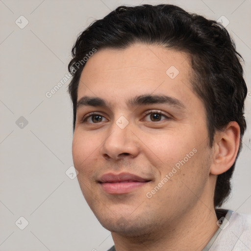 Joyful white young-adult male with short  black hair and brown eyes