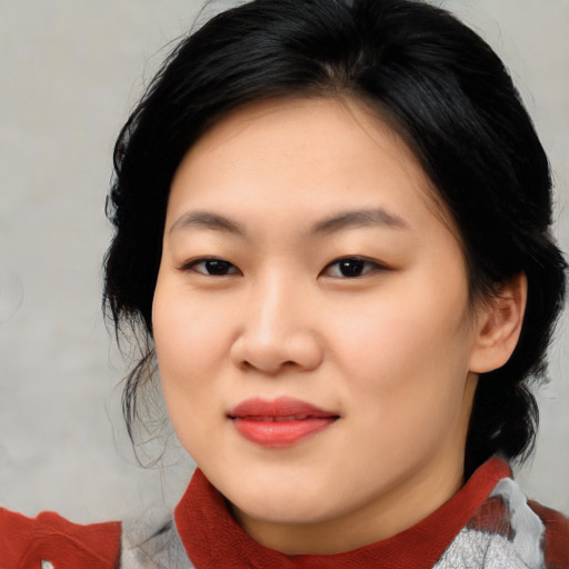 Joyful asian young-adult female with medium  black hair and brown eyes