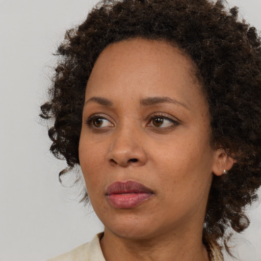 Neutral black young-adult female with medium  brown hair and brown eyes
