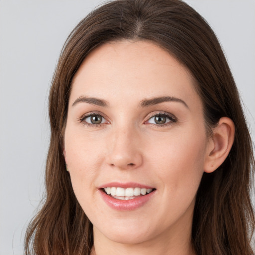 Joyful white young-adult female with long  brown hair and grey eyes