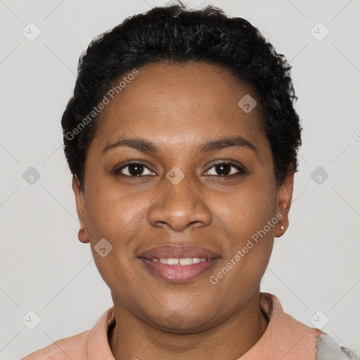 Joyful black young-adult female with short  black hair and brown eyes