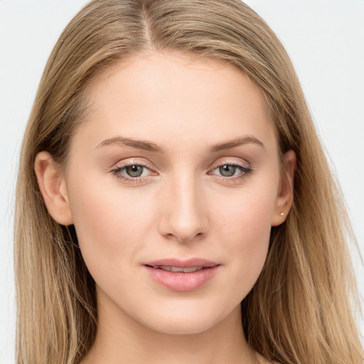 Joyful white young-adult female with long  brown hair and blue eyes