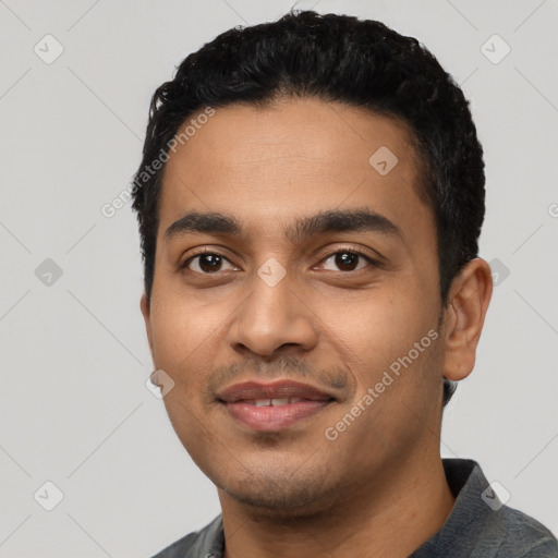 Joyful latino young-adult male with short  black hair and brown eyes