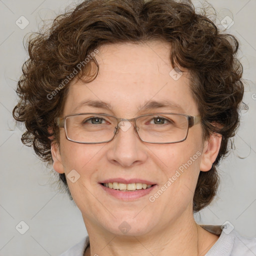 Joyful white adult female with medium  brown hair and blue eyes