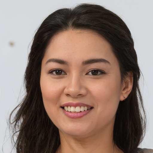 Joyful asian young-adult female with long  brown hair and brown eyes