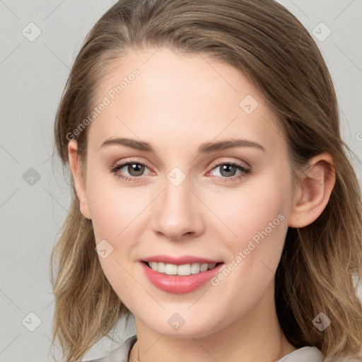 Joyful white young-adult female with medium  brown hair and blue eyes