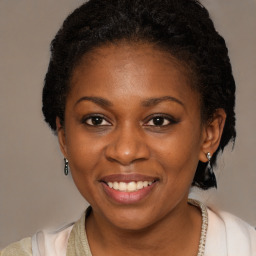 Joyful black young-adult female with medium  brown hair and brown eyes