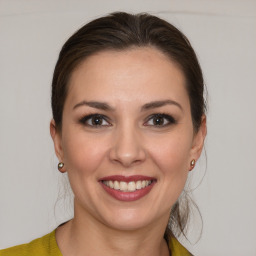 Joyful white young-adult female with medium  brown hair and brown eyes