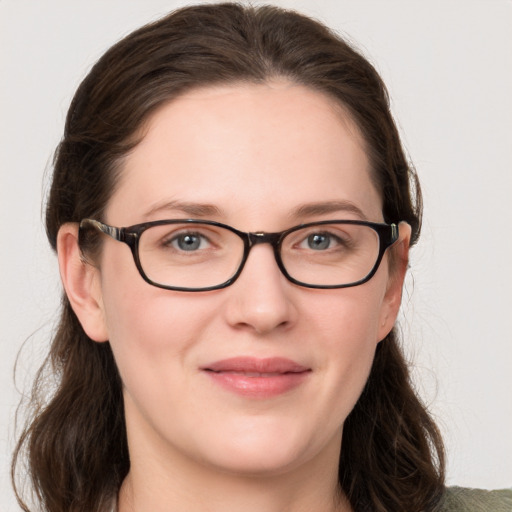 Joyful white young-adult female with medium  brown hair and grey eyes