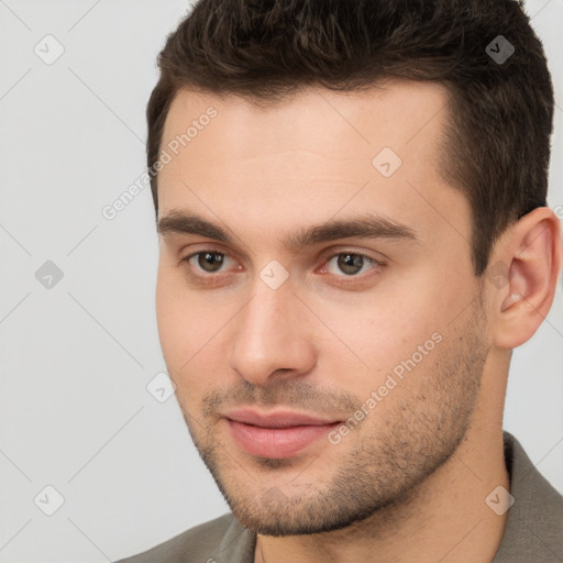 Joyful white young-adult male with short  brown hair and brown eyes