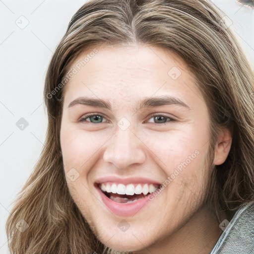 Joyful white young-adult female with long  brown hair and green eyes