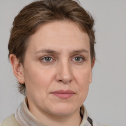 Joyful white adult female with short  brown hair and grey eyes