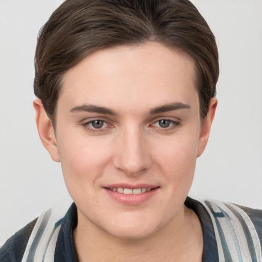 Joyful white young-adult female with short  brown hair and grey eyes