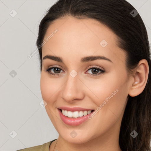 Joyful white young-adult female with long  brown hair and brown eyes