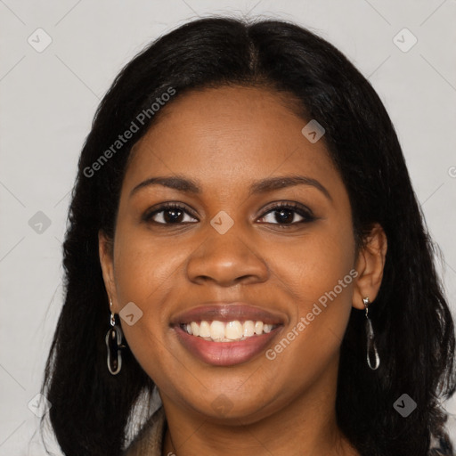 Joyful black young-adult female with long  black hair and brown eyes