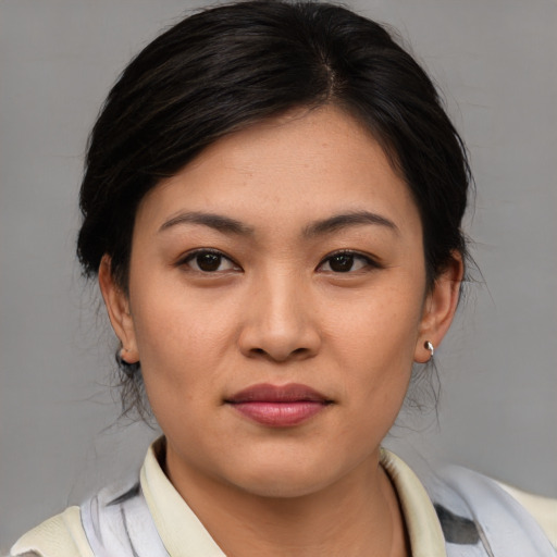 Joyful asian young-adult female with medium  brown hair and brown eyes