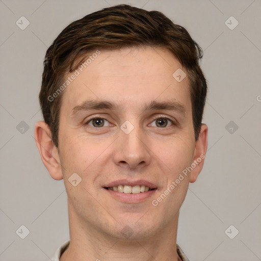 Joyful white young-adult male with short  brown hair and grey eyes