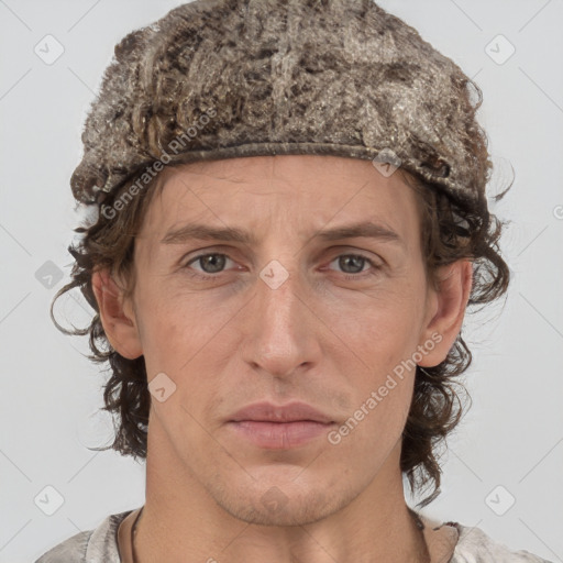 Joyful white adult male with short  brown hair and grey eyes