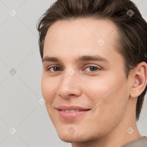 Joyful white young-adult male with short  brown hair and brown eyes