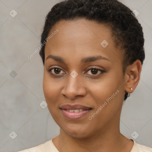 Joyful black young-adult female with short  brown hair and brown eyes