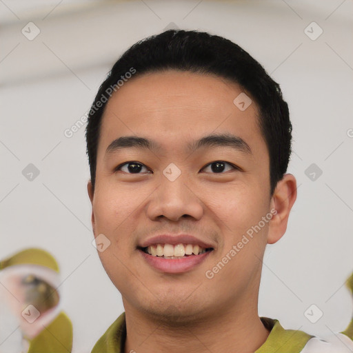 Joyful asian young-adult male with short  black hair and brown eyes