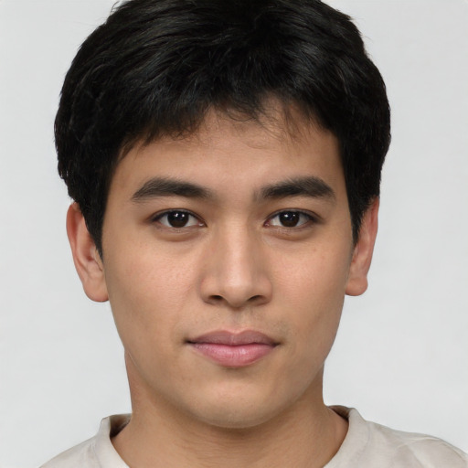 Joyful asian young-adult male with short  brown hair and brown eyes