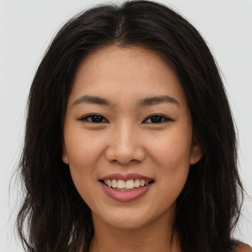 Joyful asian young-adult female with long  brown hair and brown eyes