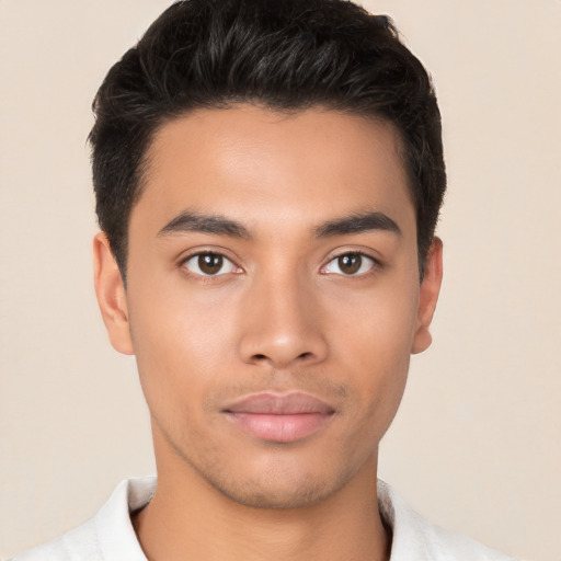 Joyful latino young-adult male with short  brown hair and brown eyes