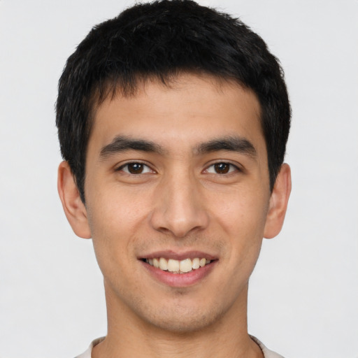 Joyful asian young-adult male with short  black hair and brown eyes