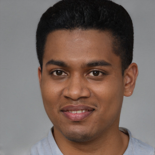 Joyful black young-adult male with short  black hair and brown eyes