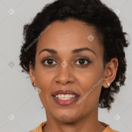 Joyful black adult female with short  brown hair and brown eyes