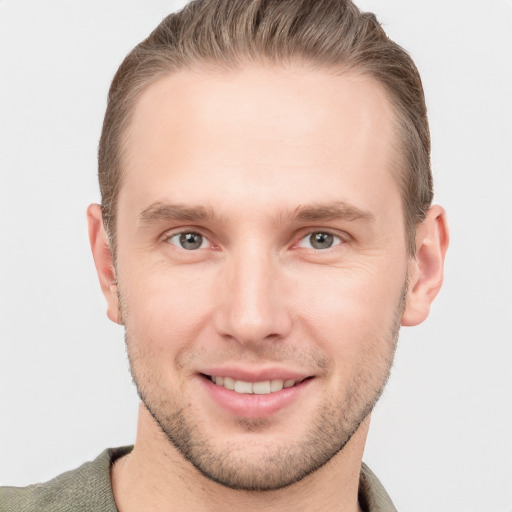 Joyful white young-adult male with short  brown hair and grey eyes