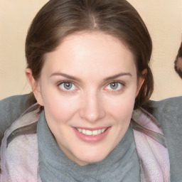 Joyful white young-adult female with medium  brown hair and blue eyes