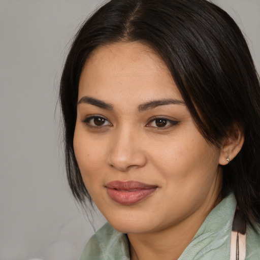 Joyful asian young-adult female with medium  brown hair and brown eyes