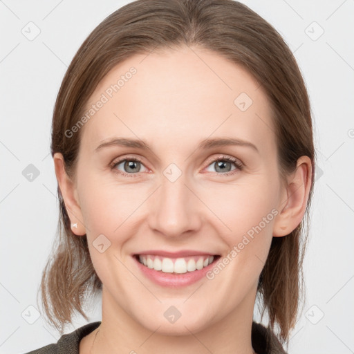 Joyful white young-adult female with medium  brown hair and blue eyes