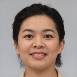 Joyful latino young-adult female with medium  brown hair and brown eyes