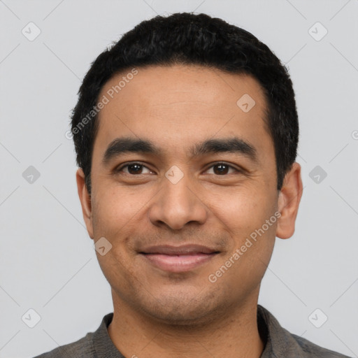 Joyful latino young-adult male with short  black hair and brown eyes