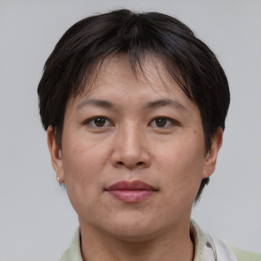 Joyful asian adult female with short  brown hair and brown eyes