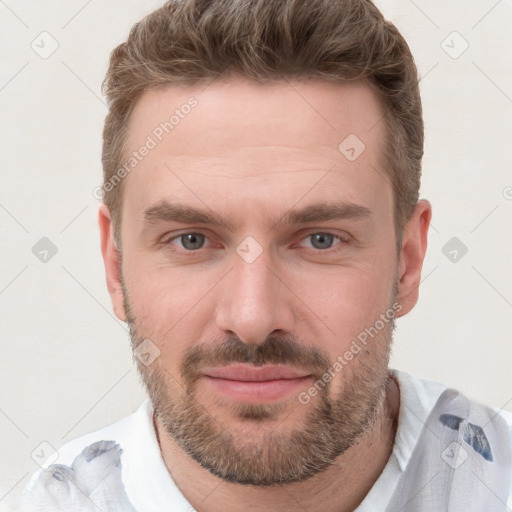 Joyful white young-adult male with short  brown hair and blue eyes