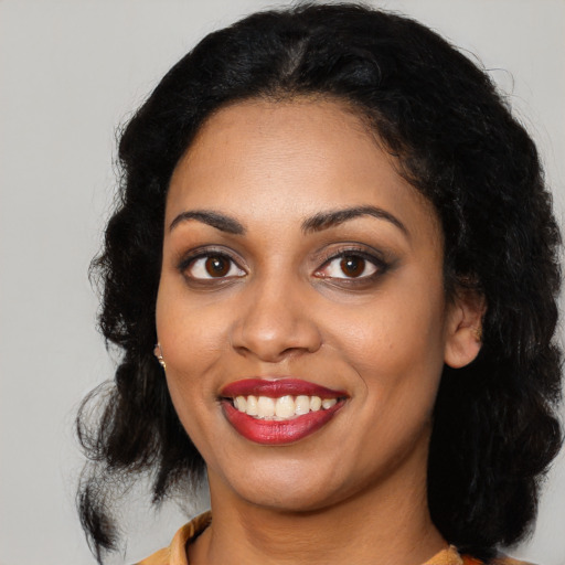 Joyful latino young-adult female with medium  black hair and brown eyes