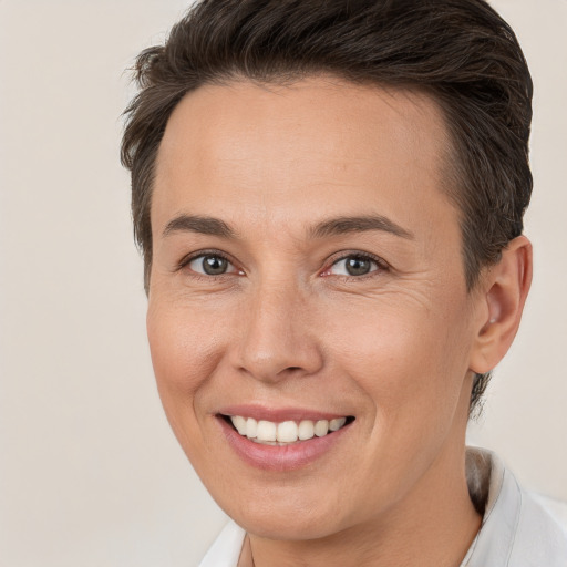 Joyful white adult female with short  brown hair and brown eyes