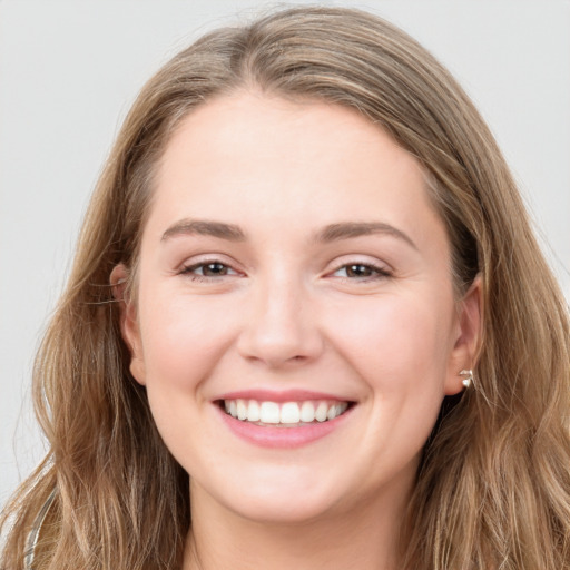 Joyful white young-adult female with long  brown hair and grey eyes